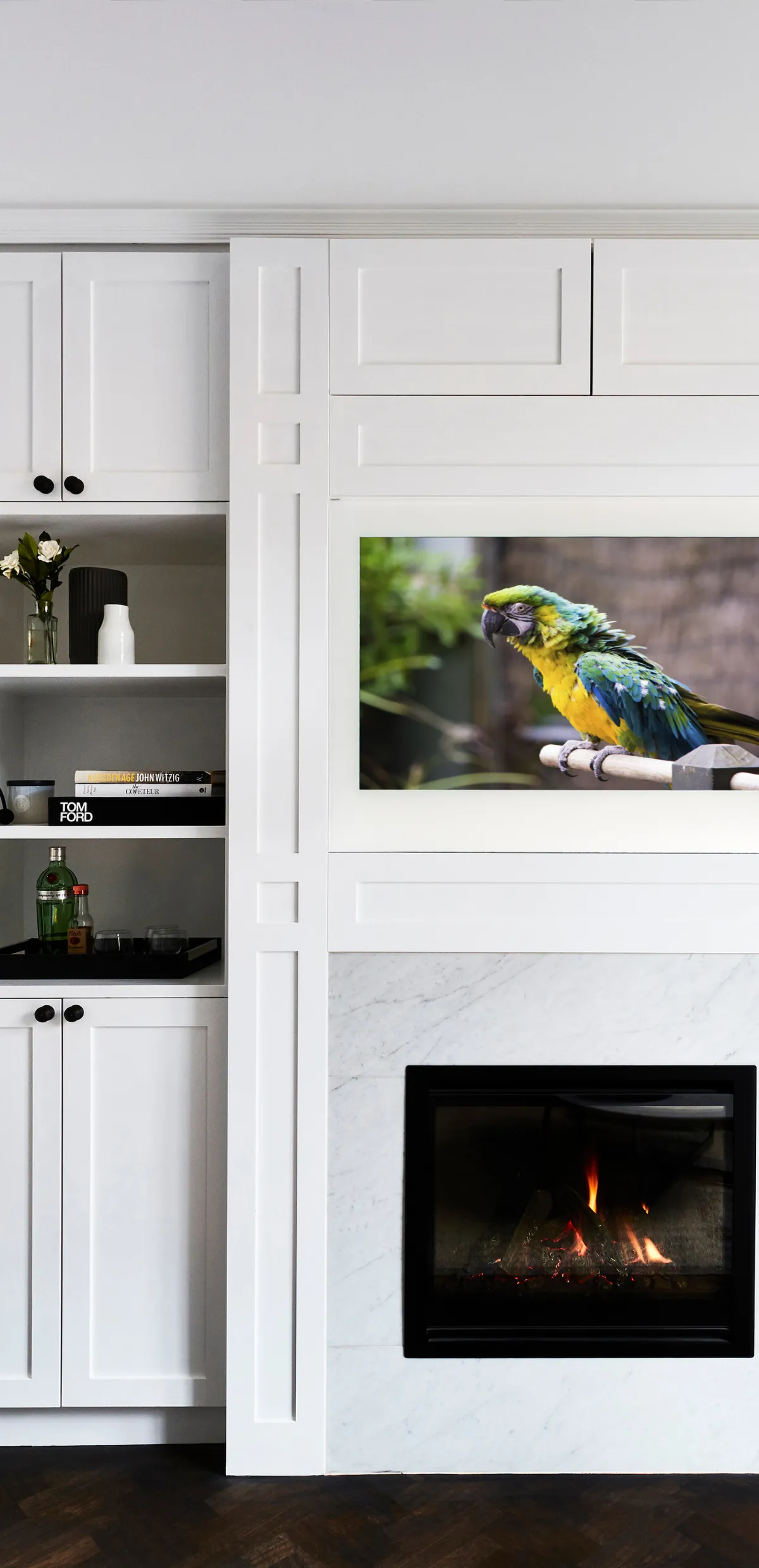 AVEL TV built into white cabinetry above a fireplace